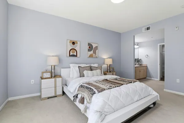 a bedroom with a bed and a lamp