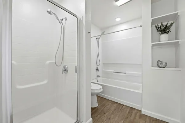 a bathroom with a shower a toilet and a shower