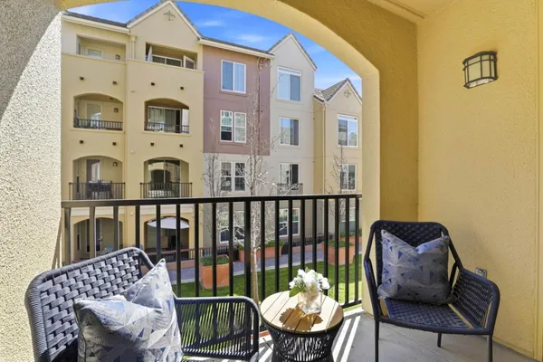 a view of a chair and table in the balcony