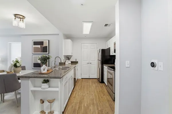 a kitchen with kitchen island a sink and appliances