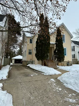 a view of a house with snow on the road