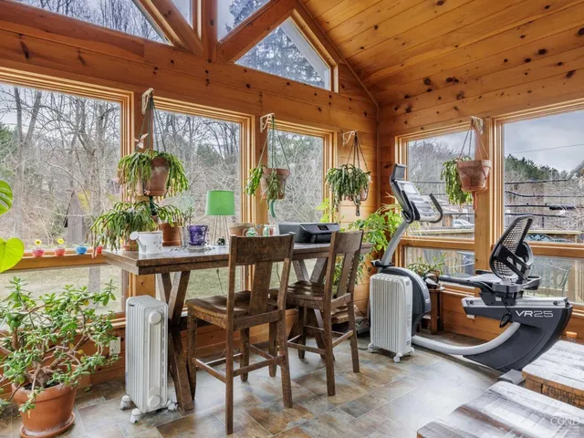 a view of a livingroom with furniture and a bookshelf