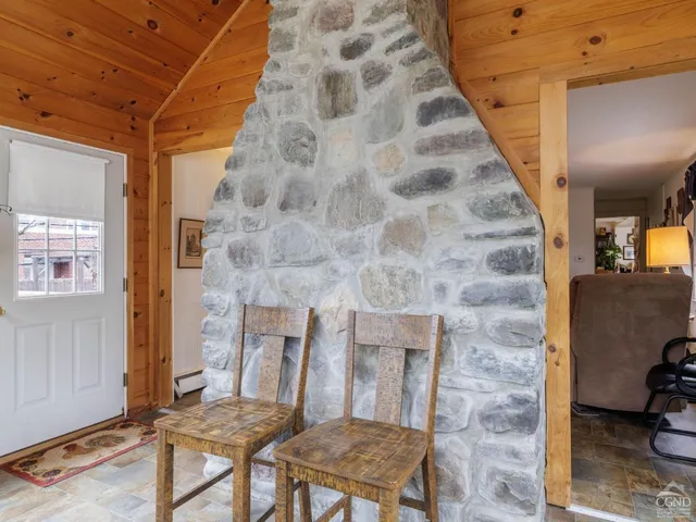 a view of a workspace with bookshelf and a window