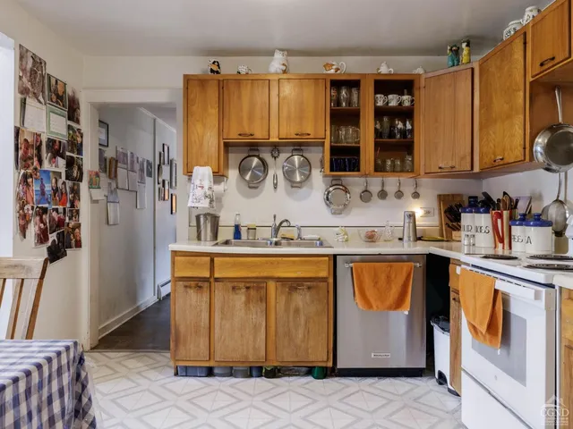 a kitchen with stainless steel appliances wooden floors and wooden cabinets