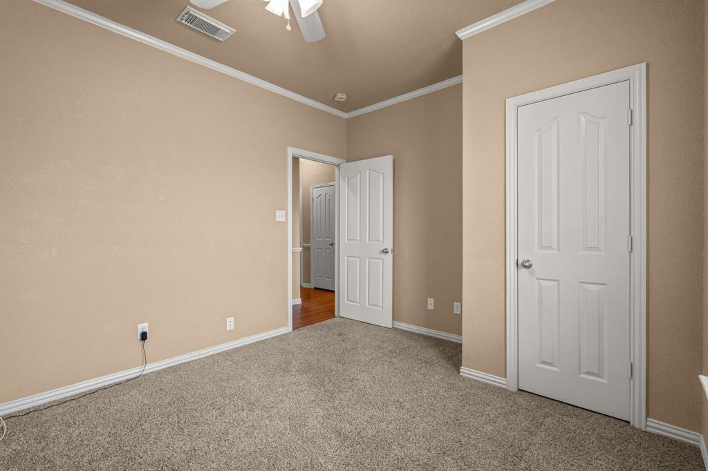 6501 Indian Trail Sanger, TX 76266 - Photo 16 of 39 Unfurnished bedroom featuring carpet flooring, ornamental molding, and ceiling fan