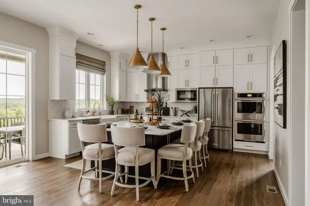 a view of kitchen with refrigerator and wooden floor