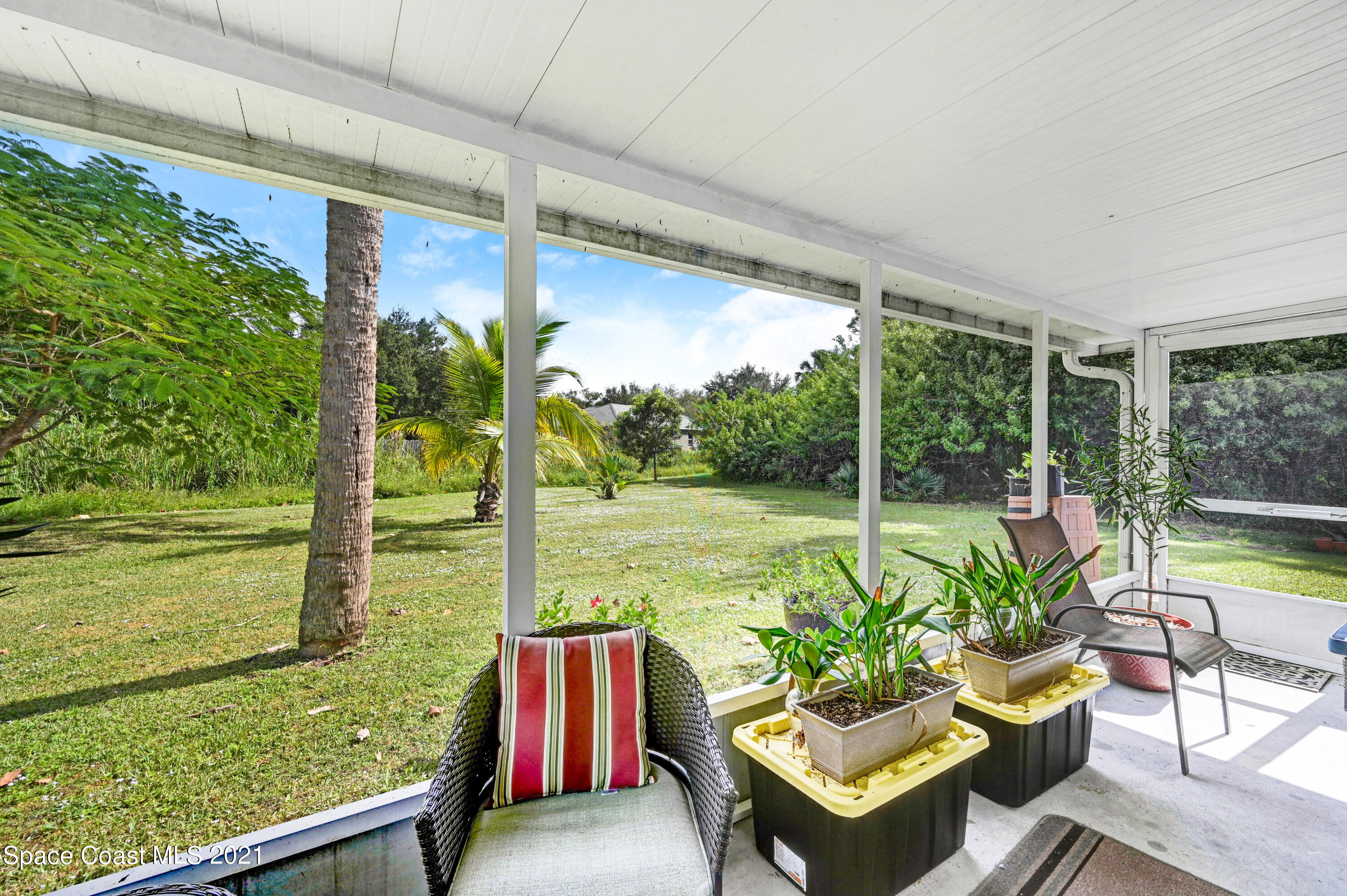 1537 Magnolia Street Northeast Palm Bay, FL 32905 - Photo 12 of 29 a balcony with chairs and a table