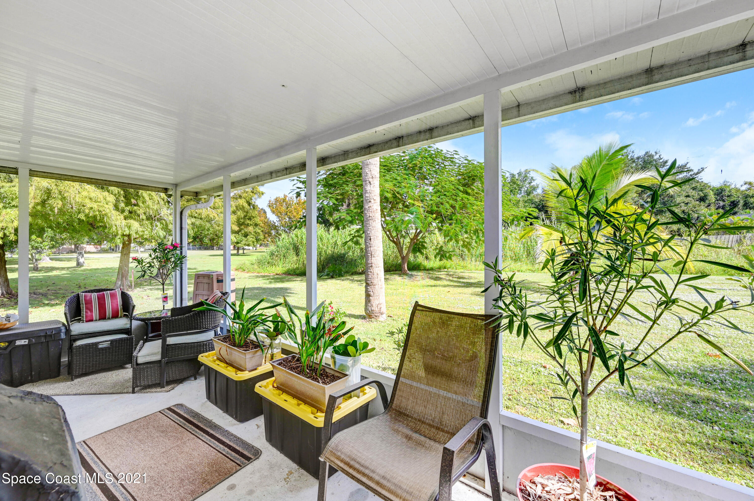 1537 Magnolia Street Northeast Palm Bay, FL 32905 - Photo 13 of 29 a living room with patio furniture and a potted plant