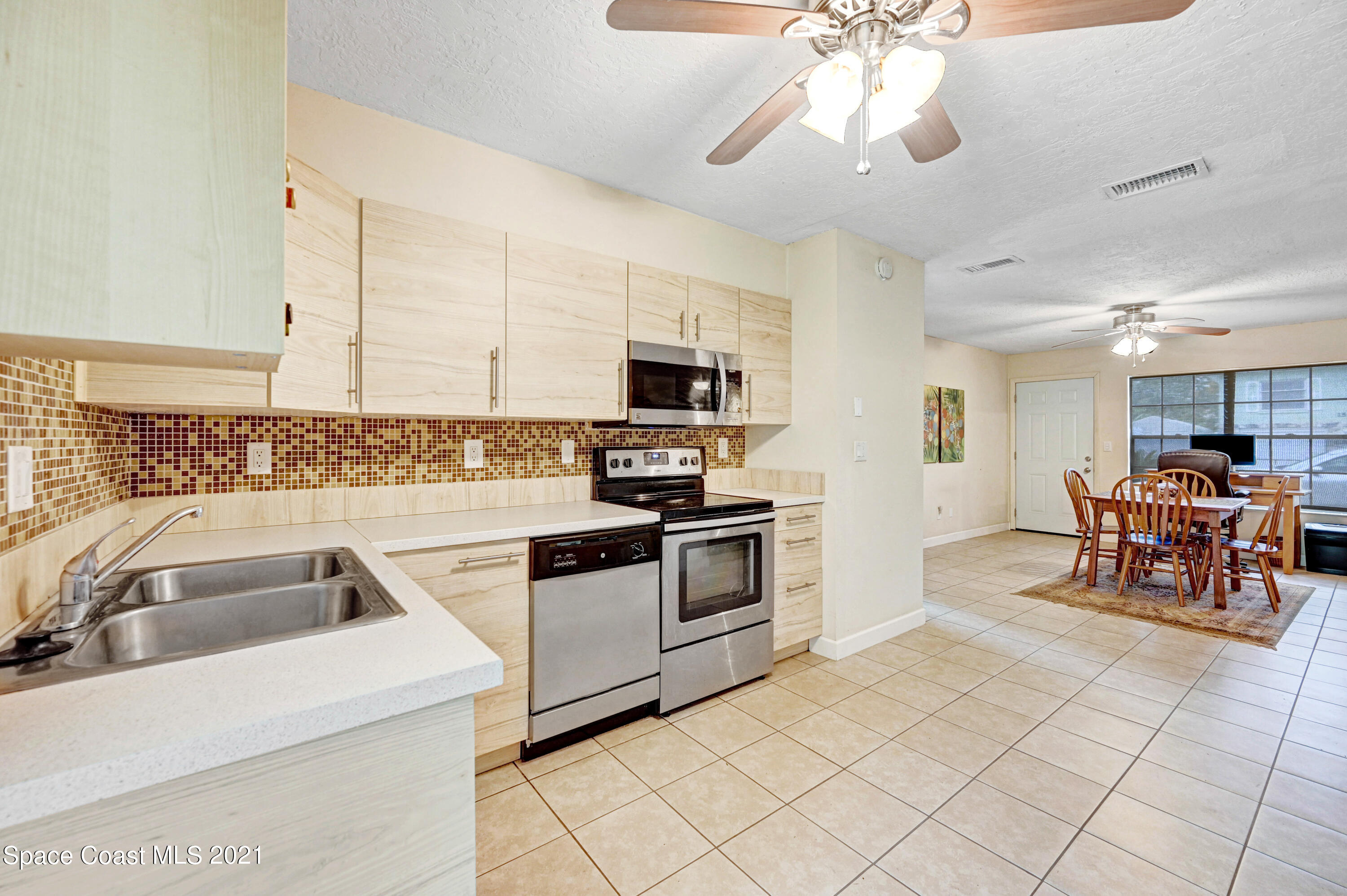 1537 Magnolia Street Northeast Palm Bay, FL 32905 - Photo 16 of 29 a kitchen with granite countertop a sink appliances and cabinets