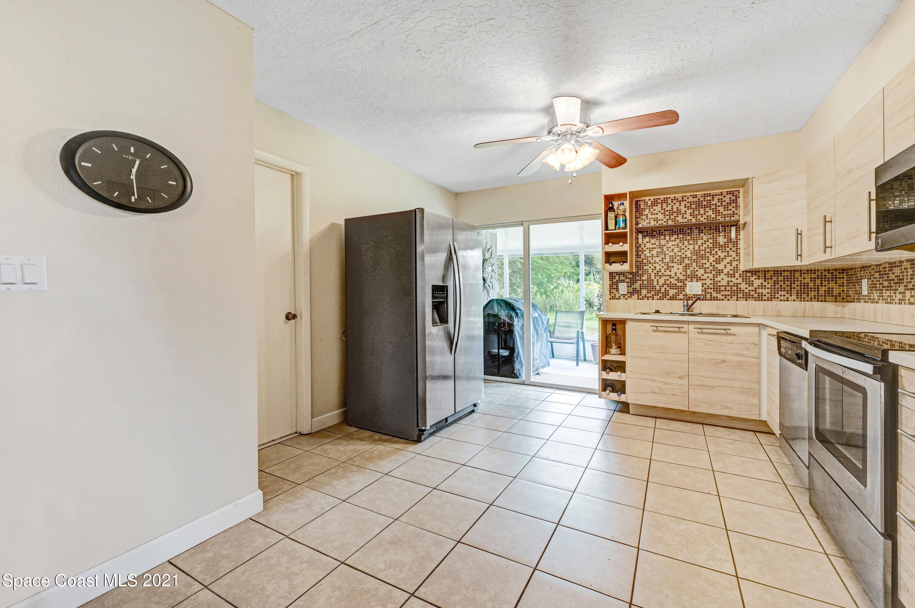 1537 Magnolia Street Northeast Palm Bay, FL 32905 - Photo 17 of 29 a large kitchen with stainless steel appliances granite countertop a refrigerator a stove and a sink