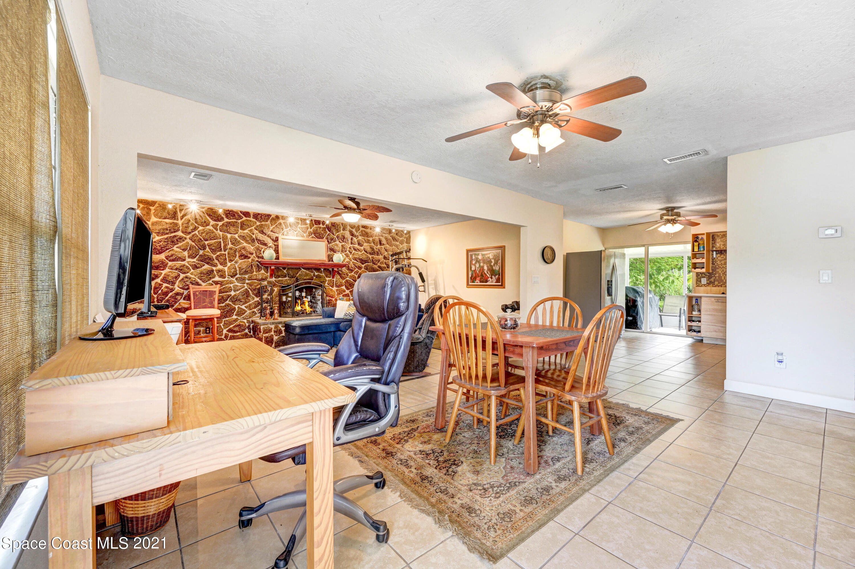 1537 Magnolia Street Northeast Palm Bay, FL 32905 - Photo 20 of 29 a dining room with furniture a chandelier and a large window