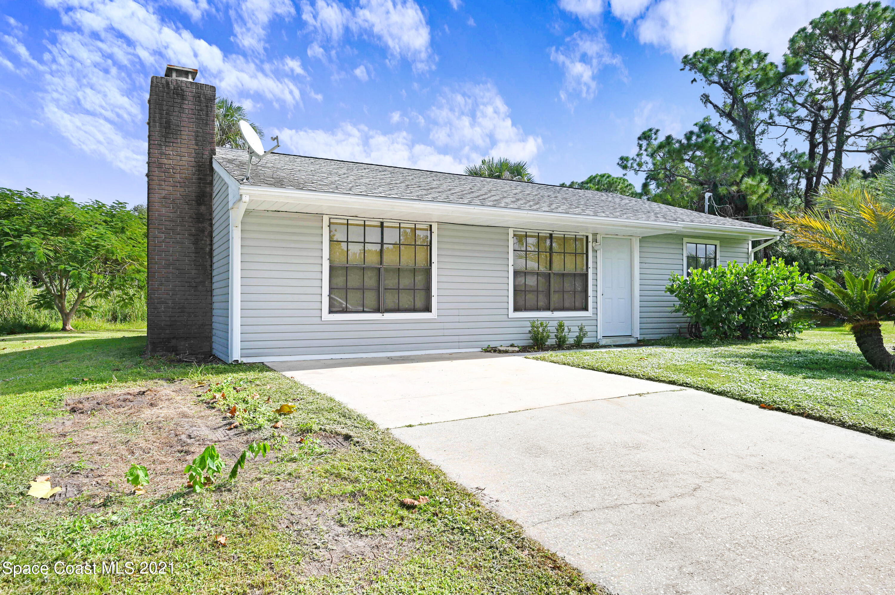 1537 Magnolia Street Northeast Palm Bay, FL 32905 - Photo 2 of 29 a house view with a garden space
