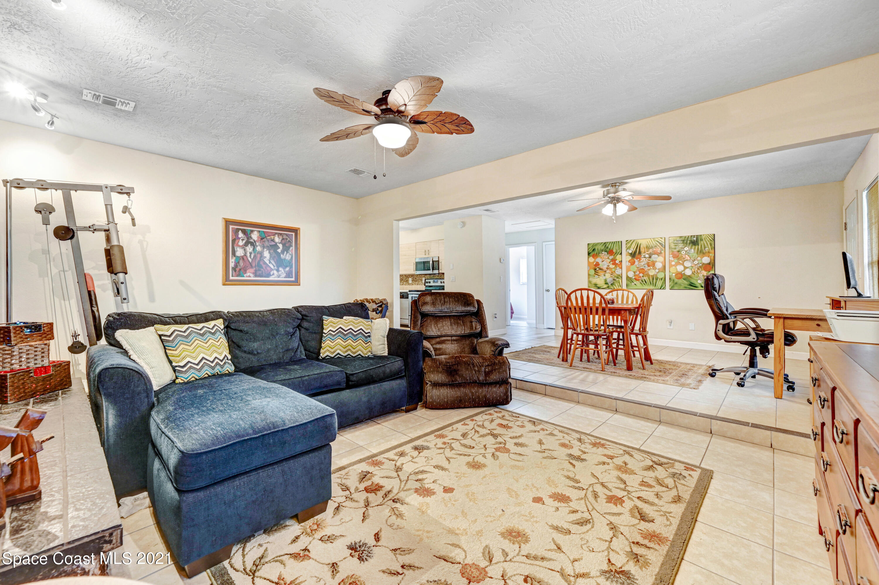 1537 Magnolia Street Northeast Palm Bay, FL 32905 - Photo 22 of 29 a living room with furniture and a rug
