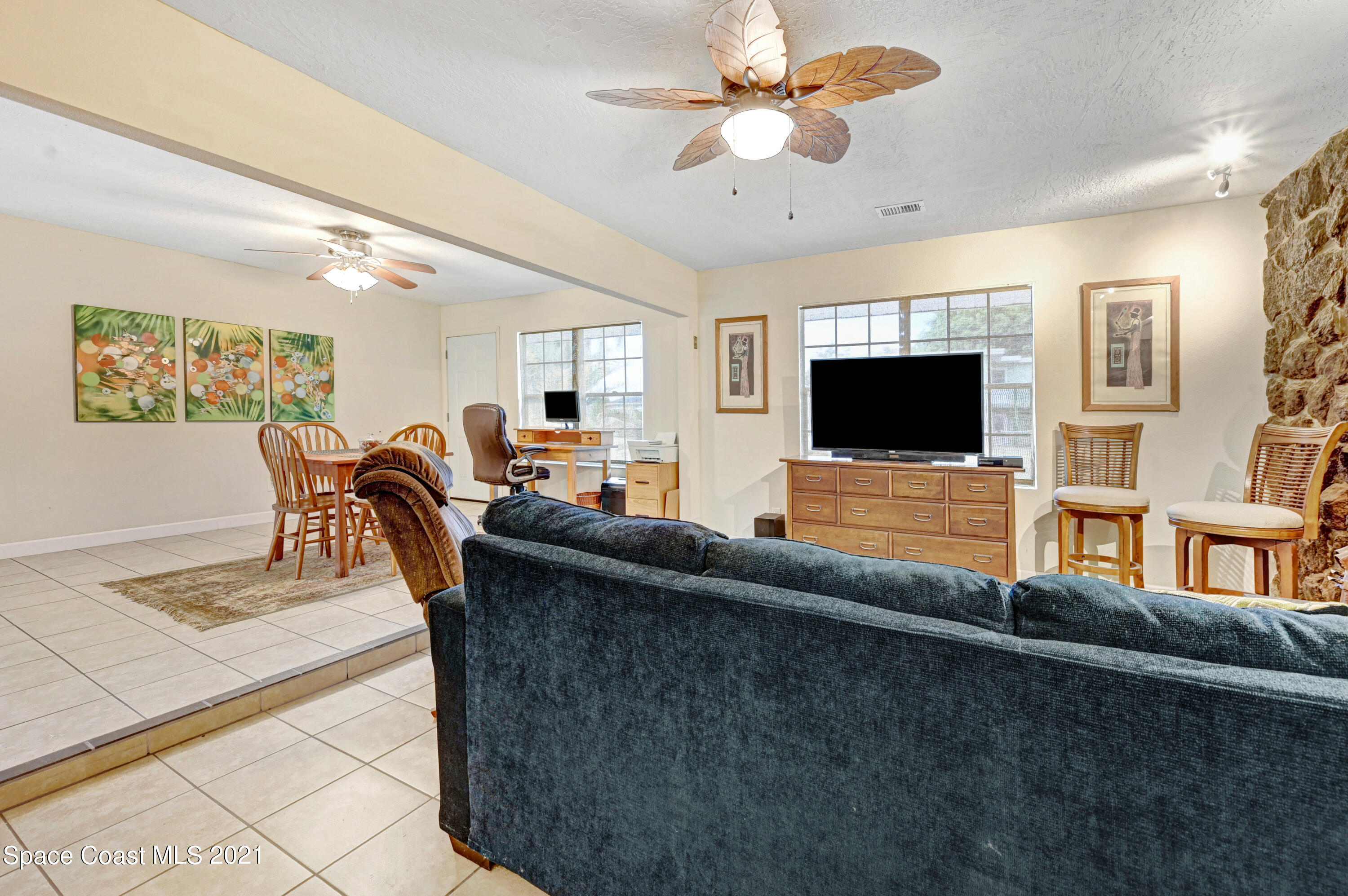 1537 Magnolia Street Northeast Palm Bay, FL 32905 - Photo 23 of 29 a living room with furniture and a flat screen tv