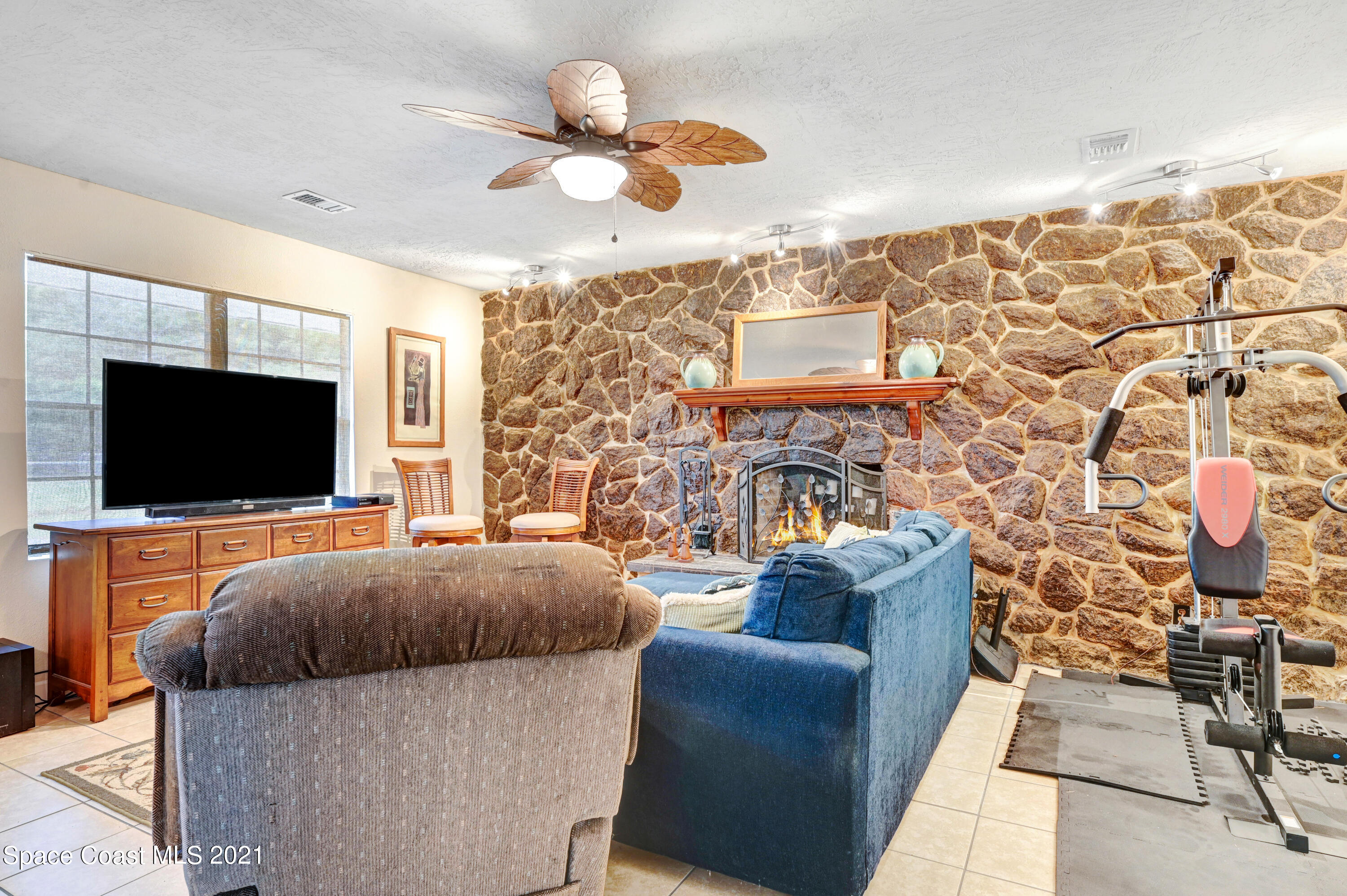 1537 Magnolia Street Northeast Palm Bay, FL 32905 - Photo 24 of 29 a living room with furniture and a flat screen tv