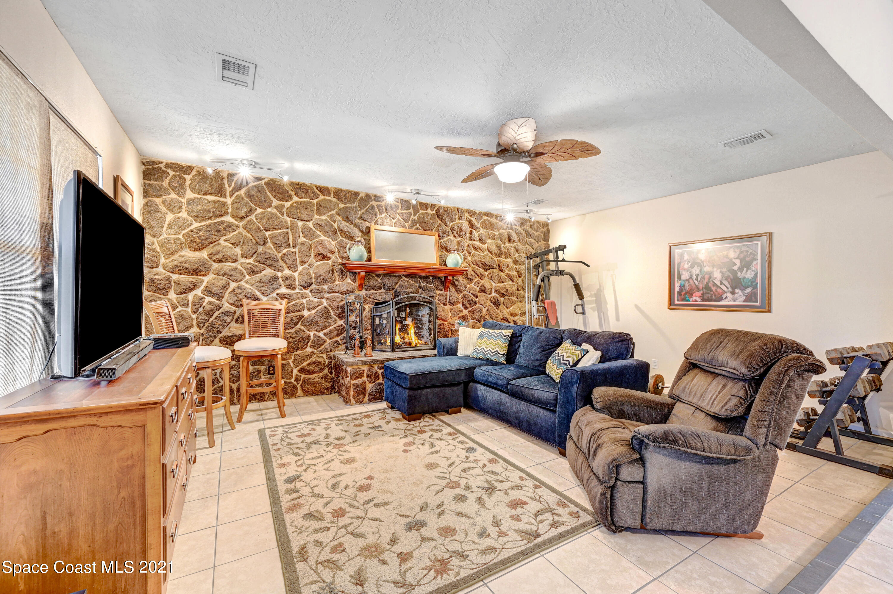 1537 Magnolia Street Northeast Palm Bay, FL 32905 - Photo 25 of 29 a living room with furniture and a flat screen tv