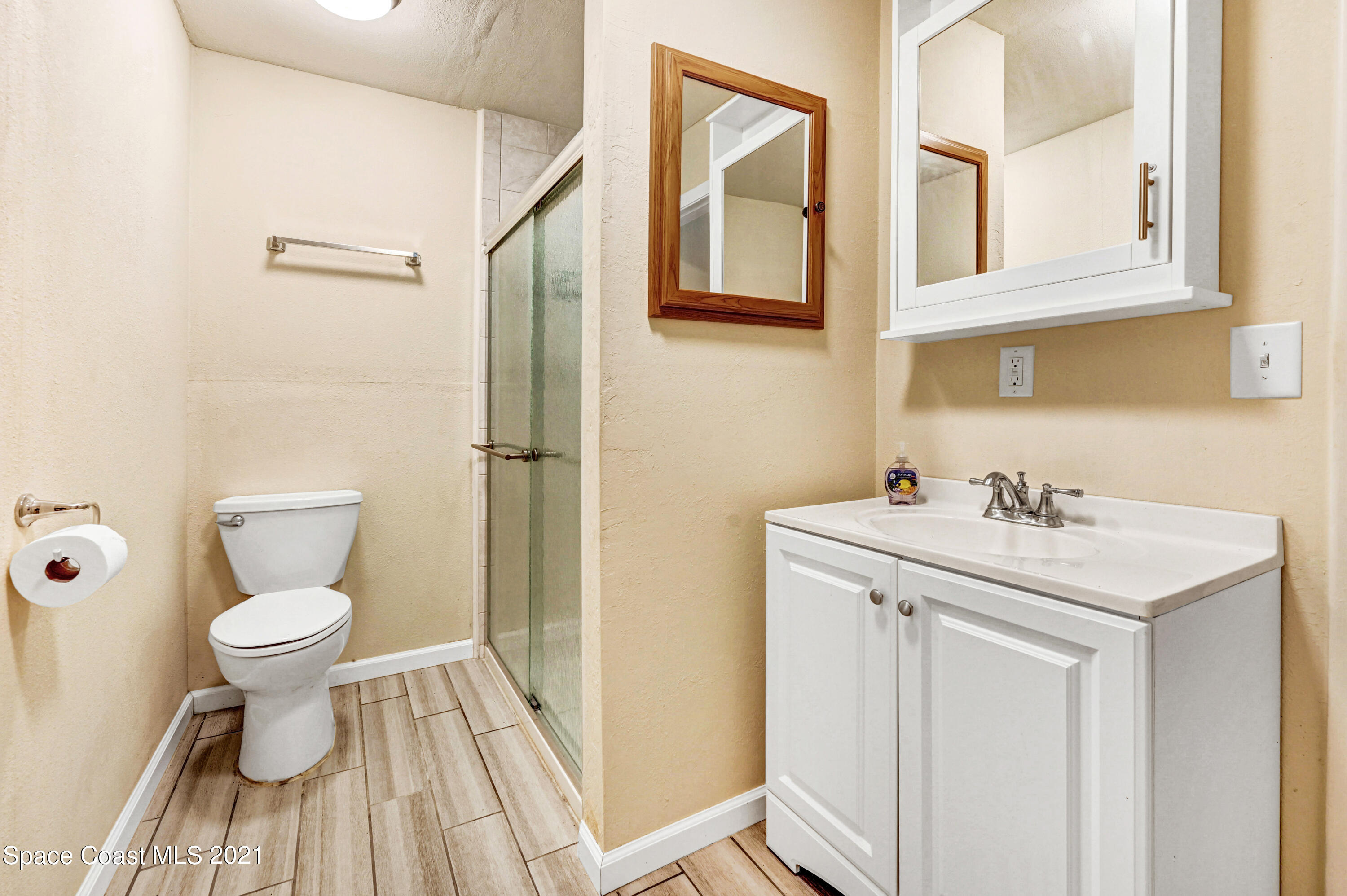 1537 Magnolia Street Northeast Palm Bay, FL 32905 - Photo 27 of 29 a bathroom with a sink toilet and a mirror