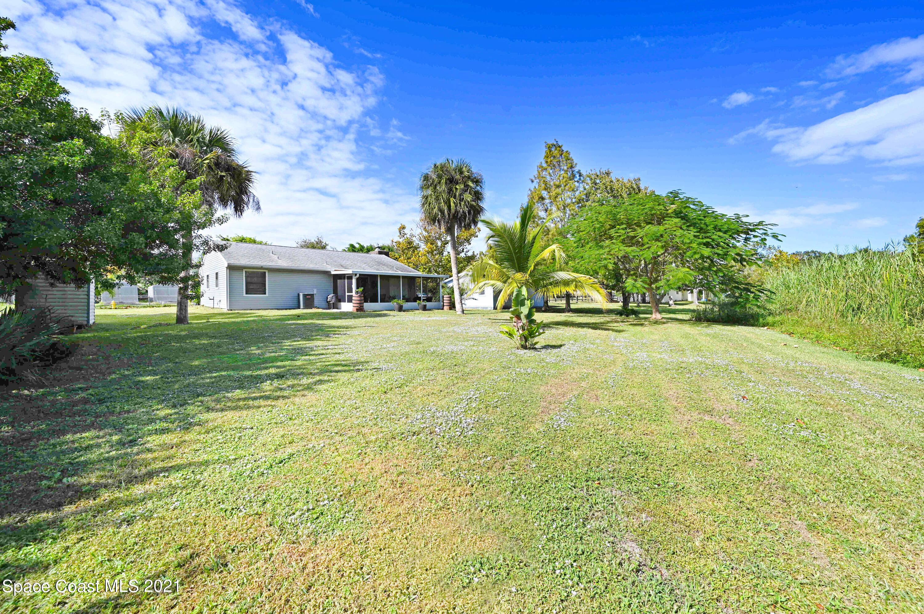 1537 Magnolia Street Northeast Palm Bay, FL 32905 - Photo 7 of 29 a view of a house with a yard