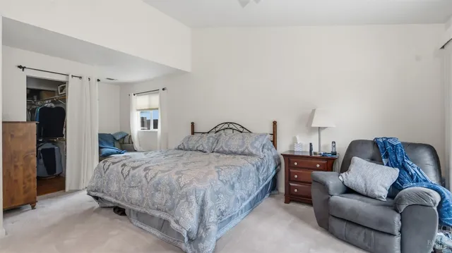 a bedroom with a bed and a couch