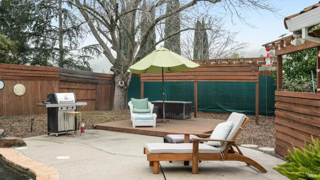 a backyard of a house with table and chairs
