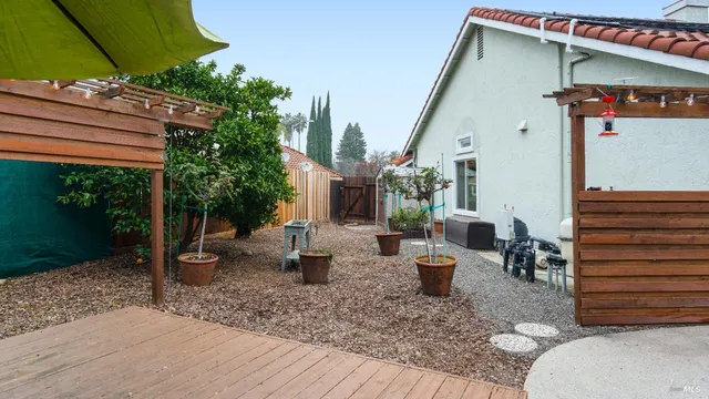 a view of a house with backyard and sitting area