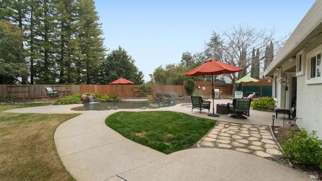 a view of a backyard with sitting area