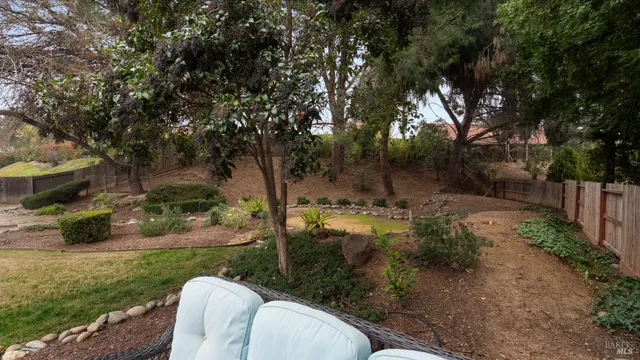 a front view of a house with yard patio and swimming pool