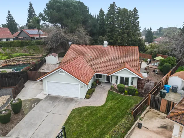 an aerial view of a house with a yard