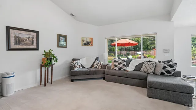 a living room with furniture and windows