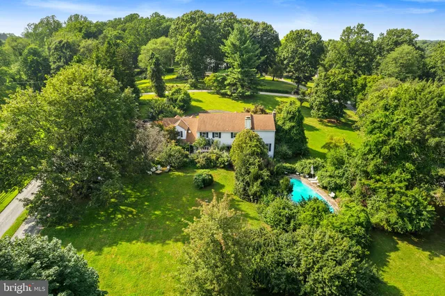 an aerial view of a house with a garden and swimming pool