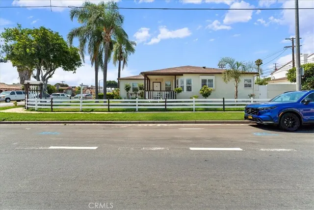 a front view of a house with a garden and fire pit
