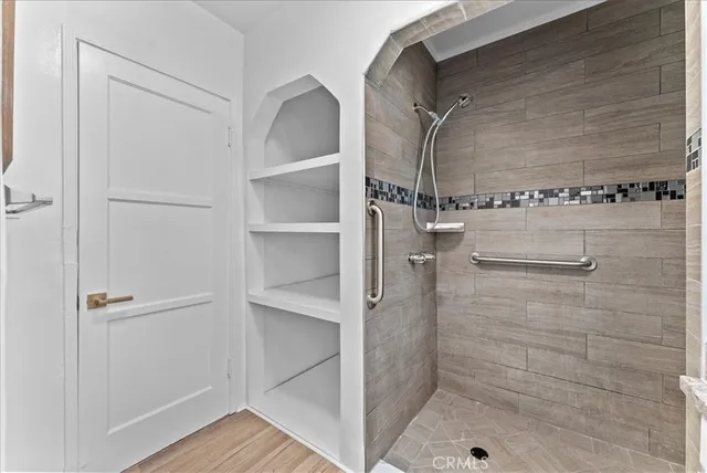 a view of a hallway with wooden floor and closet