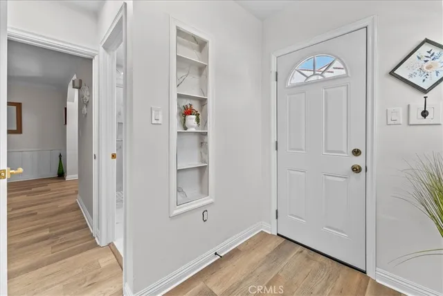 a view of a large room with wooden floor and furniture