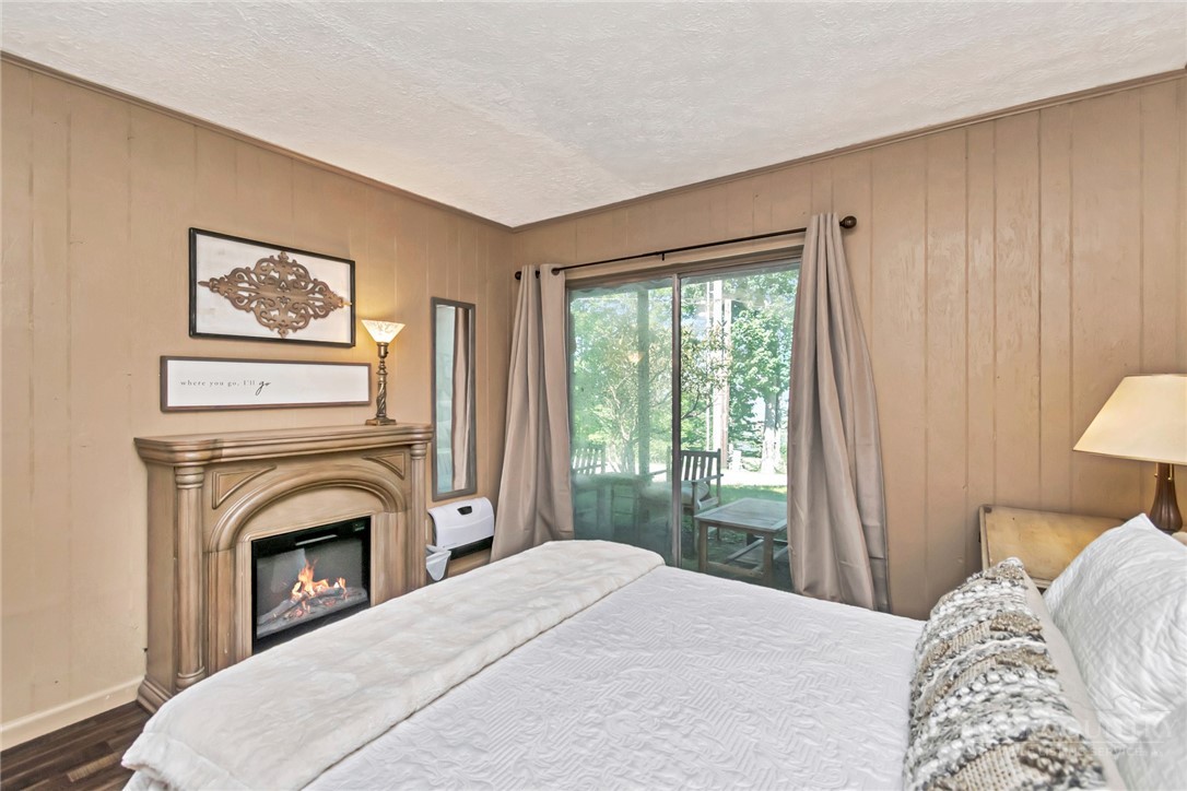 115 North Pinnacle Ridge Road, Unit 46 Beech Mountain, NC 28604 - Photo 31 of 42 a bedroom with a bed and a fireplace