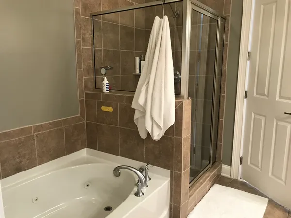 a bathroom with a bath tub and shower
