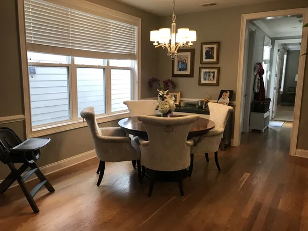 a view of a dining room with furniture window and wooden floor