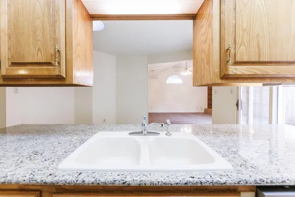 a bathroom with a granite countertop sink and a mirror