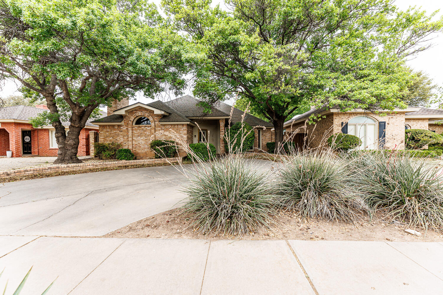 7610 Utica Avenue Lubbock, TX 79424 - Photo 2 of 49 a front view of a house with a yard