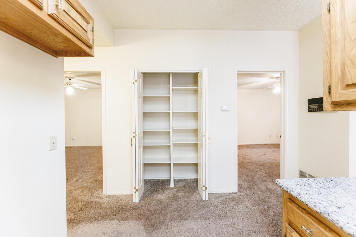7610 Utica Avenue Lubbock, TX 79424 - Photo 22 of 49 a view of walk in closet with empty racks