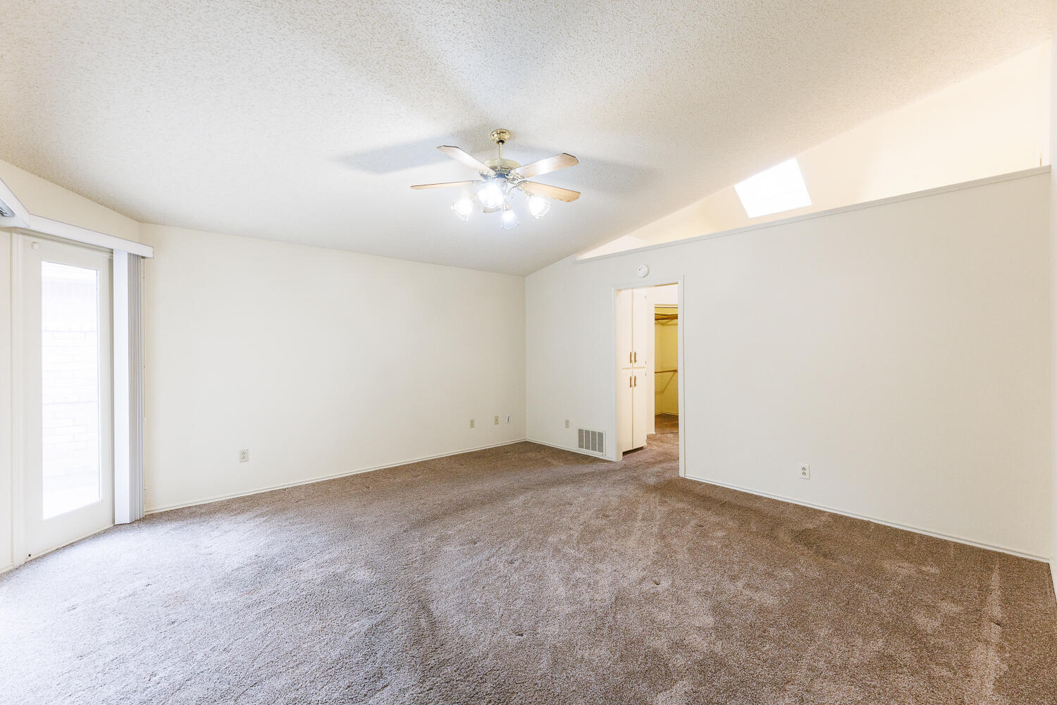 7610 Utica Avenue Lubbock, TX 79424 - Photo 23 of 49 an empty room with a ceiling fan and a window