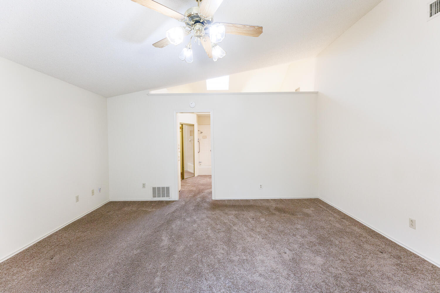 7610 Utica Avenue Lubbock, TX 79424 - Photo 24 of 49 an empty room with a ceiling fan and a window