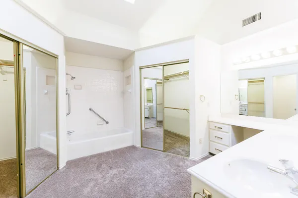 a view of a bathroom with a tub sink and mirror