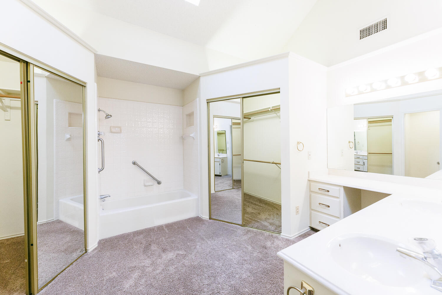7610 Utica Avenue Lubbock, TX 79424 - Photo 26 of 49 a view of a bathroom with a tub sink and mirror