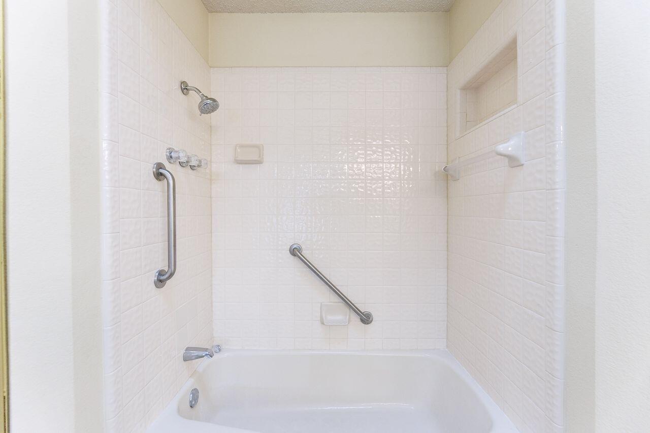 7610 Utica Avenue Lubbock, TX 79424 - Photo 29 of 49 a bathroom with a bath tub