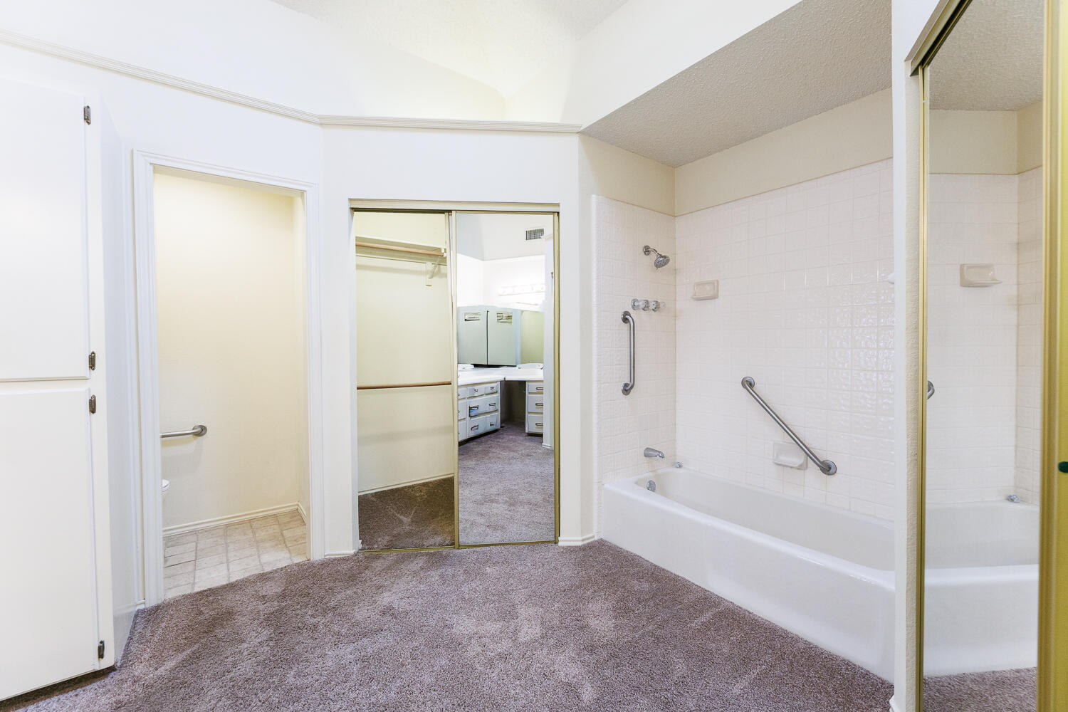 7610 Utica Avenue Lubbock, TX 79424 - Photo 31 of 49 a view of a bathroom with a tub and a hallway