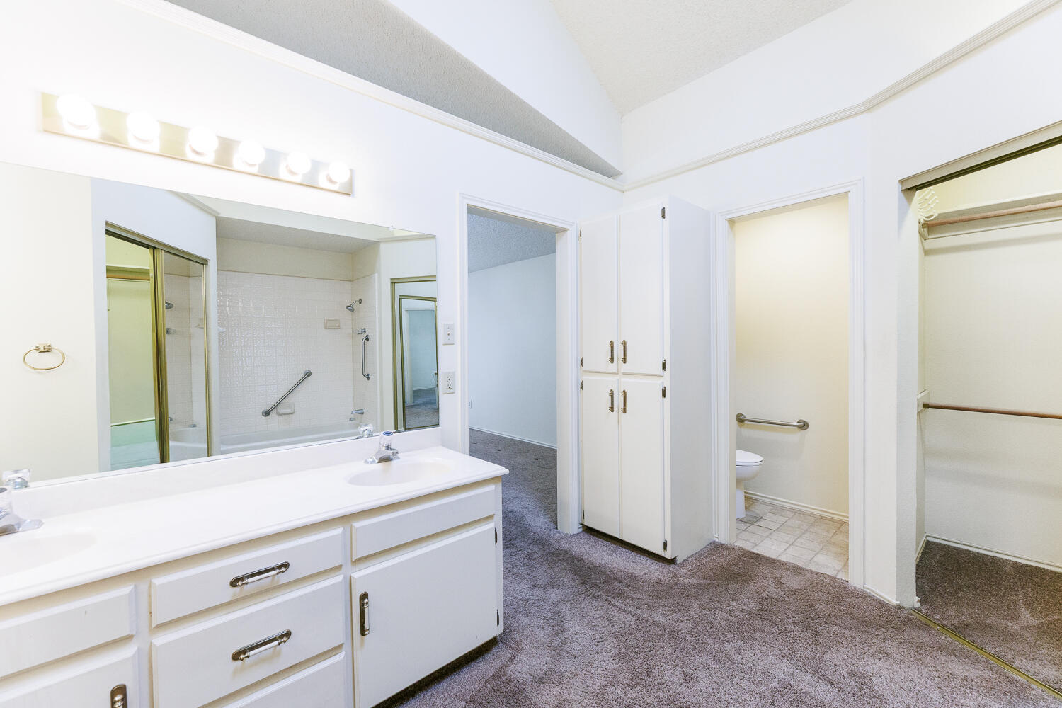 7610 Utica Avenue Lubbock, TX 79424 - Photo 32 of 49 a bathroom with a double vanity sink and mirror