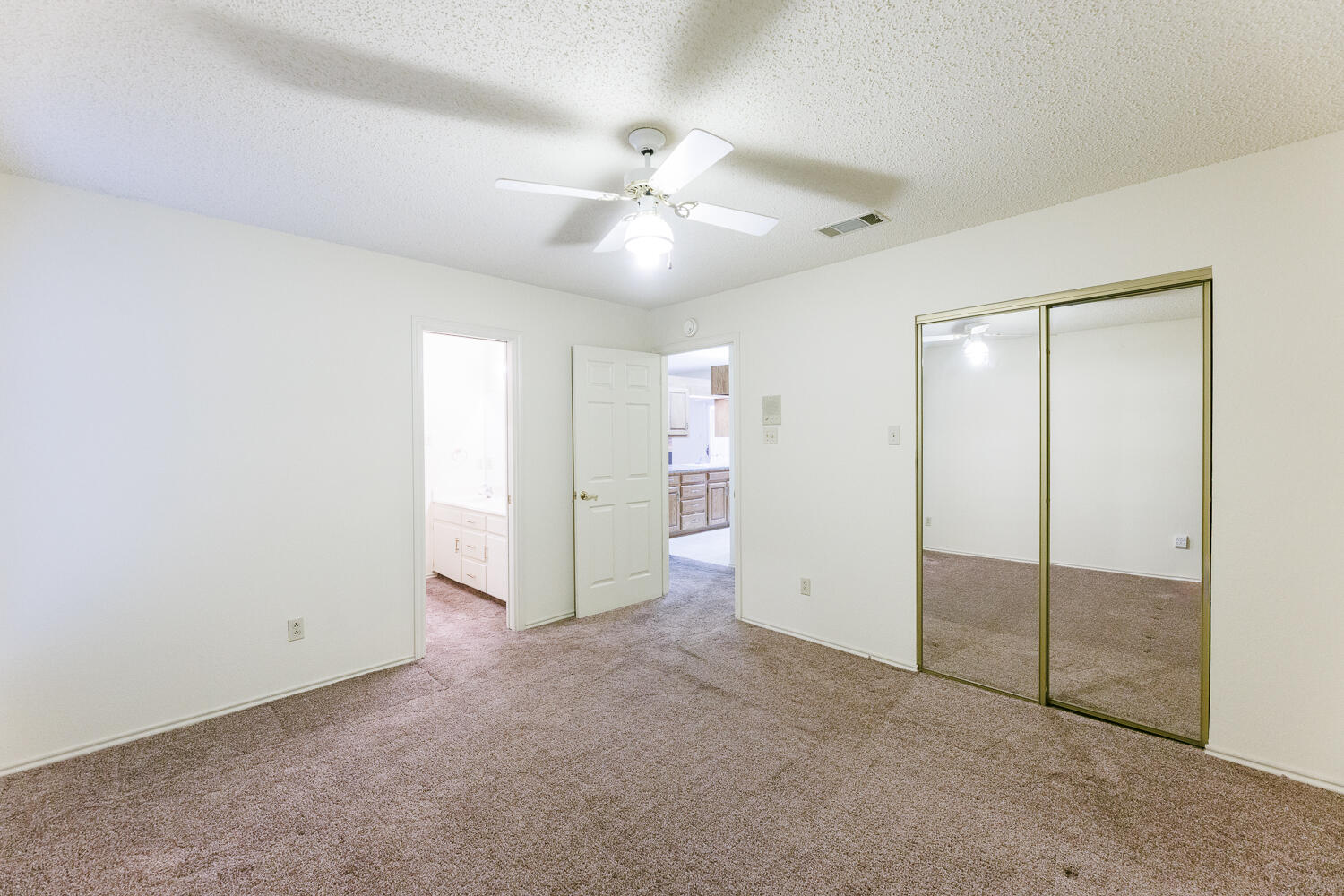 7610 Utica Avenue Lubbock, TX 79424 - Photo 33 of 49 an empty room with closet and a ceiling fan