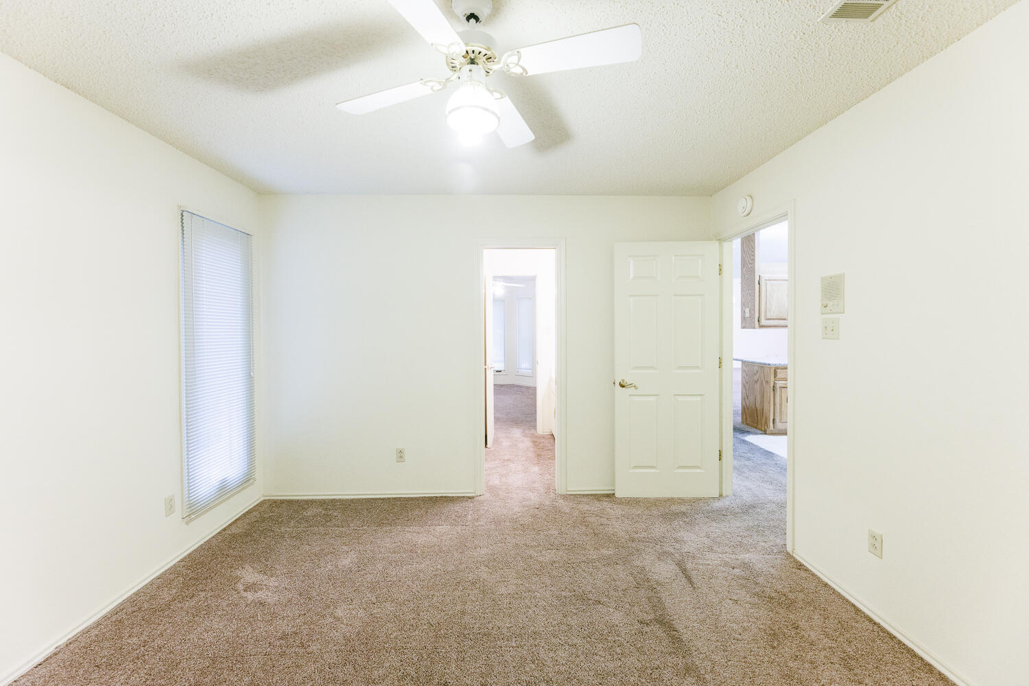 7610 Utica Avenue Lubbock, TX 79424 - Photo 34 of 49 an empty room with fan and entrance