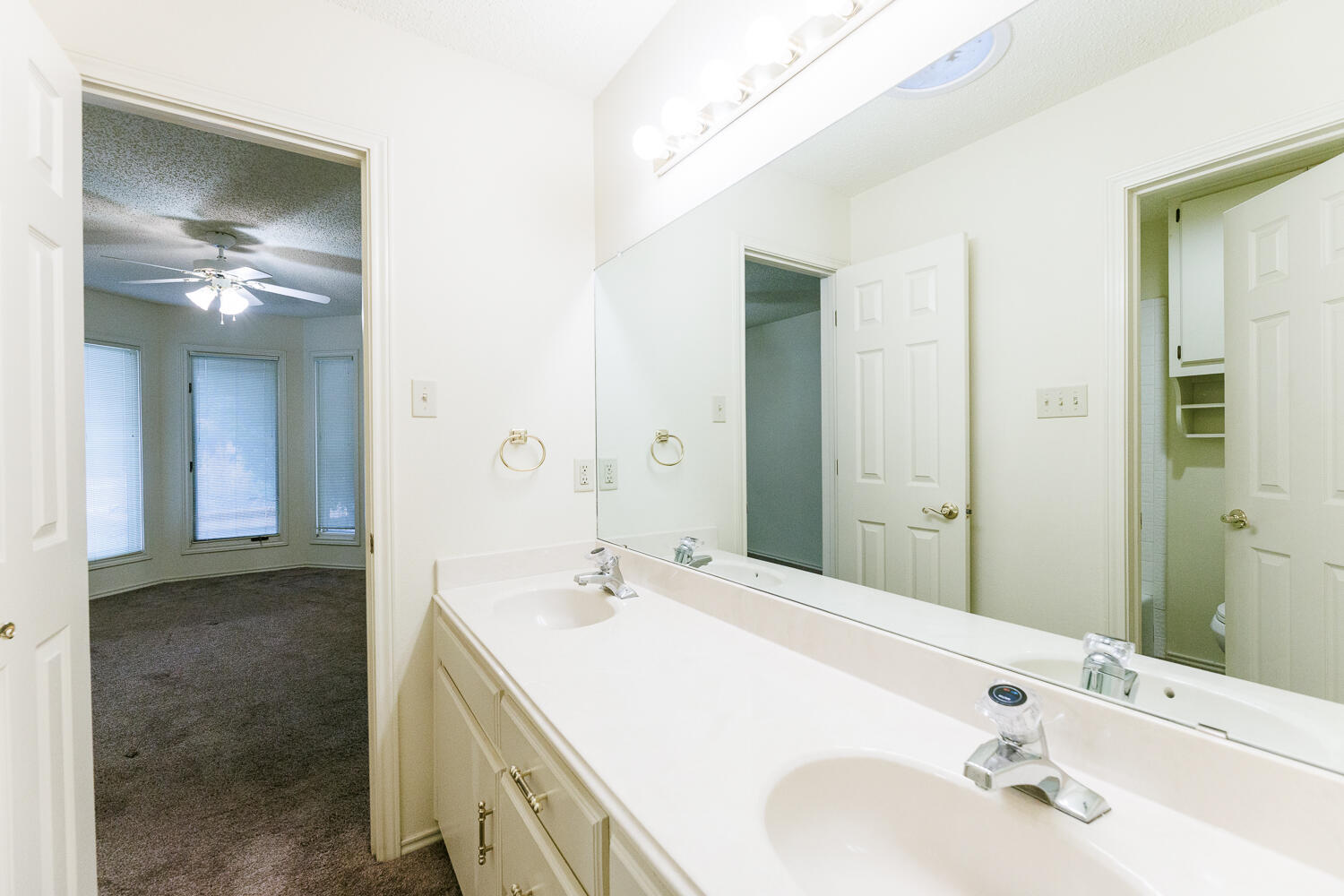 7610 Utica Avenue Lubbock, TX 79424 - Photo 36 of 49 a bathroom with a sink and a mirror