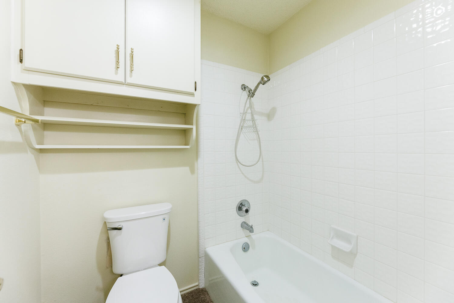 7610 Utica Avenue Lubbock, TX 79424 - Photo 37 of 49 a bathroom with a toilet and a bathtub